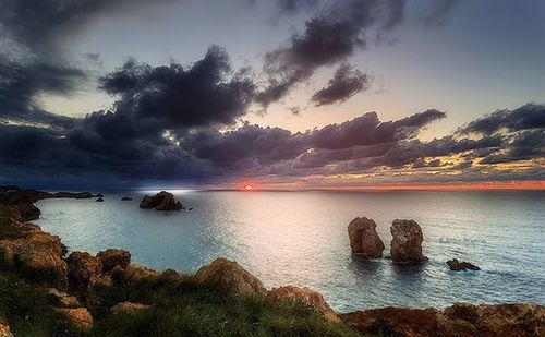 Scenic view of sea against cloudy sky