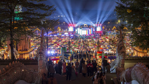 Crowd at illuminated city during celebration at night