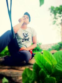 Full length of girl sitting outdoors