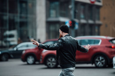 Full length of man standing on street in city