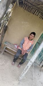 High angle portrait of a smiling man lying outdoors