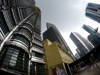 Low angle view of modern skyscrapers in city against sky