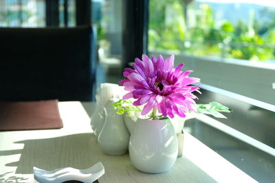 Close-up of pink flower vase on table at home