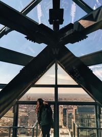 Rear view of woman at one liberty observation deck against cityscape