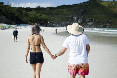 Rear view of couple at beach