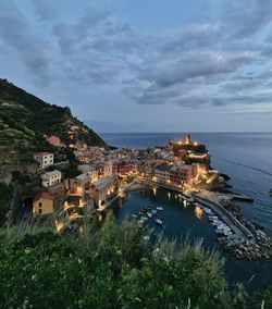 Aerial view of buildings and sea against sky