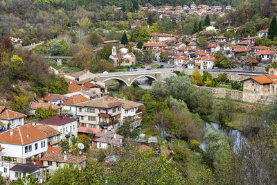 High angle view of townscape by river in city