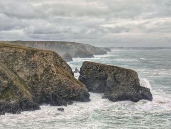 Scenic view of rocks in sea against sky