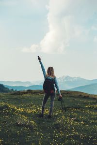 Full length of woman standing on field against sky