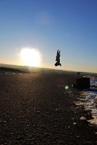 Man in sea against sky