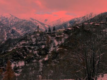 Scenic view of snowcapped mountains against sky at sunset