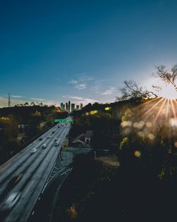 Road in city against sky on sunny day