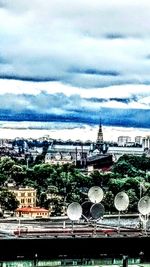 View of cityscape against cloudy sky