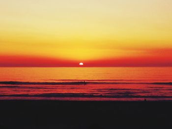 Scenic view of sea against orange sky