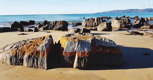 Panoramic view of rocks on beach against sky