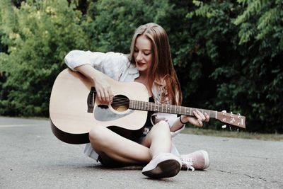 Young woman playing guitar