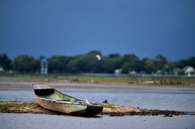 Boat in lake against sky