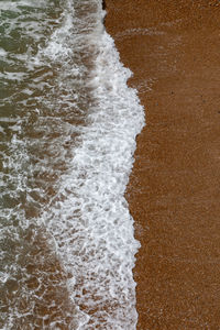 High angle view of surf on beach