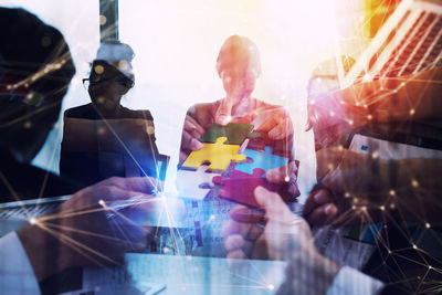 Digital composite image of people holding glass
