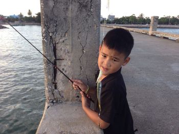 Boy standing by river