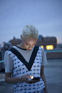 Young woman hanging out on a building rooftop