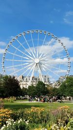 View of ferris wheel against blue sky
