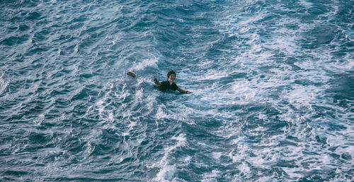 High angle view of man surfing in sea