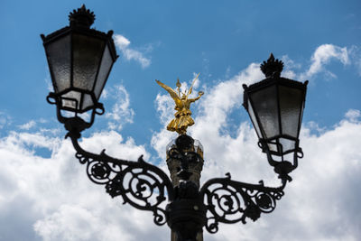 Low angle view of street light and berlin victory column against sky