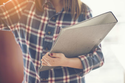 Close-up of a woman holding paper