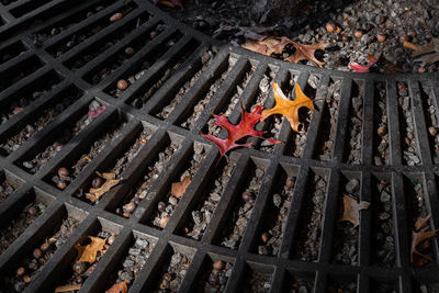 High angle view of metal grate on barbecue grill