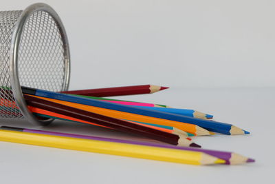 Close-up of colored pencils on white background