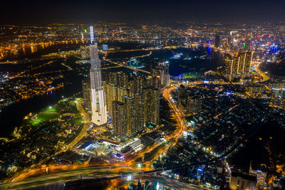 High angle view of city lit up at night