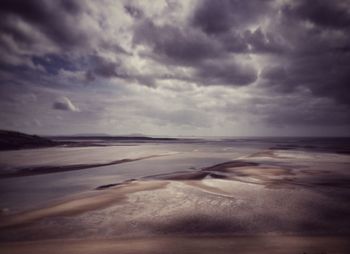 Scenic view of sea against cloudy sky