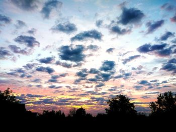 Low angle view of silhouette trees against sky during sunset