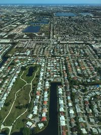 High angle view of cityscape by sea against sky