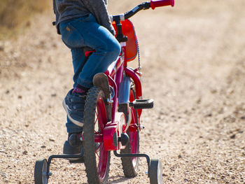 Low section of boy riding bicycle