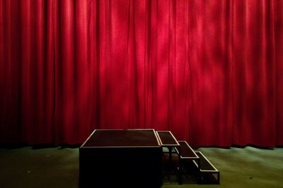 Red curtain hanging on stage