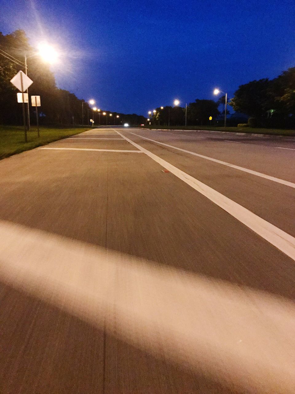 VIEW OF EMPTY ROAD ALONG NIGHT