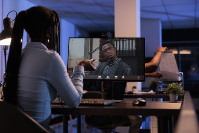 Businesswoman talking with colleague on video call