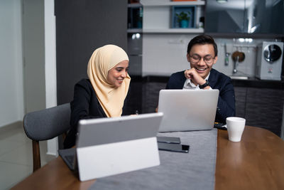 Business people working at desk in office cafeteria