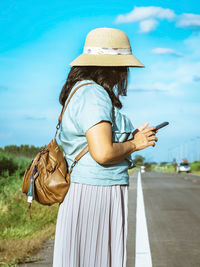 Midsection of woman holding smart phone