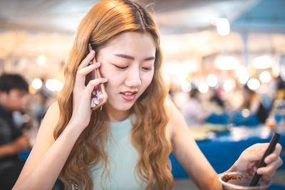 Young woman using mobile phone outdoors