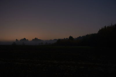 Scenic view of silhouette landscape against clear sky during sunset