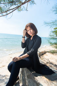 Young woman sitting on beach