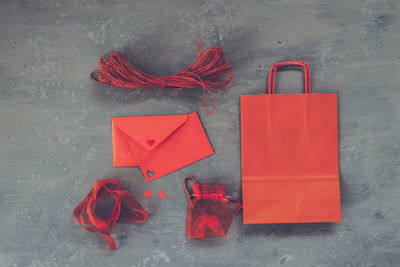 Directly above shot of red crafty materials on table