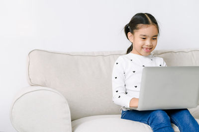 Girl sitting on sofa at home