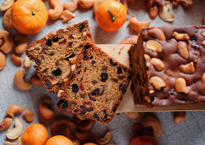 Sliced fruit cake with cashew nuts and oranges