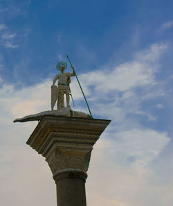 Low angle view of statue against cloudy sky