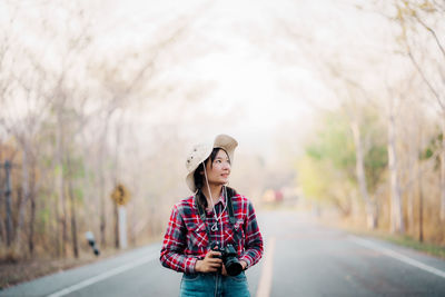 Side view of man standing on road