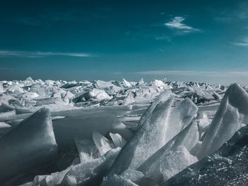 Icebergs in sea against sky